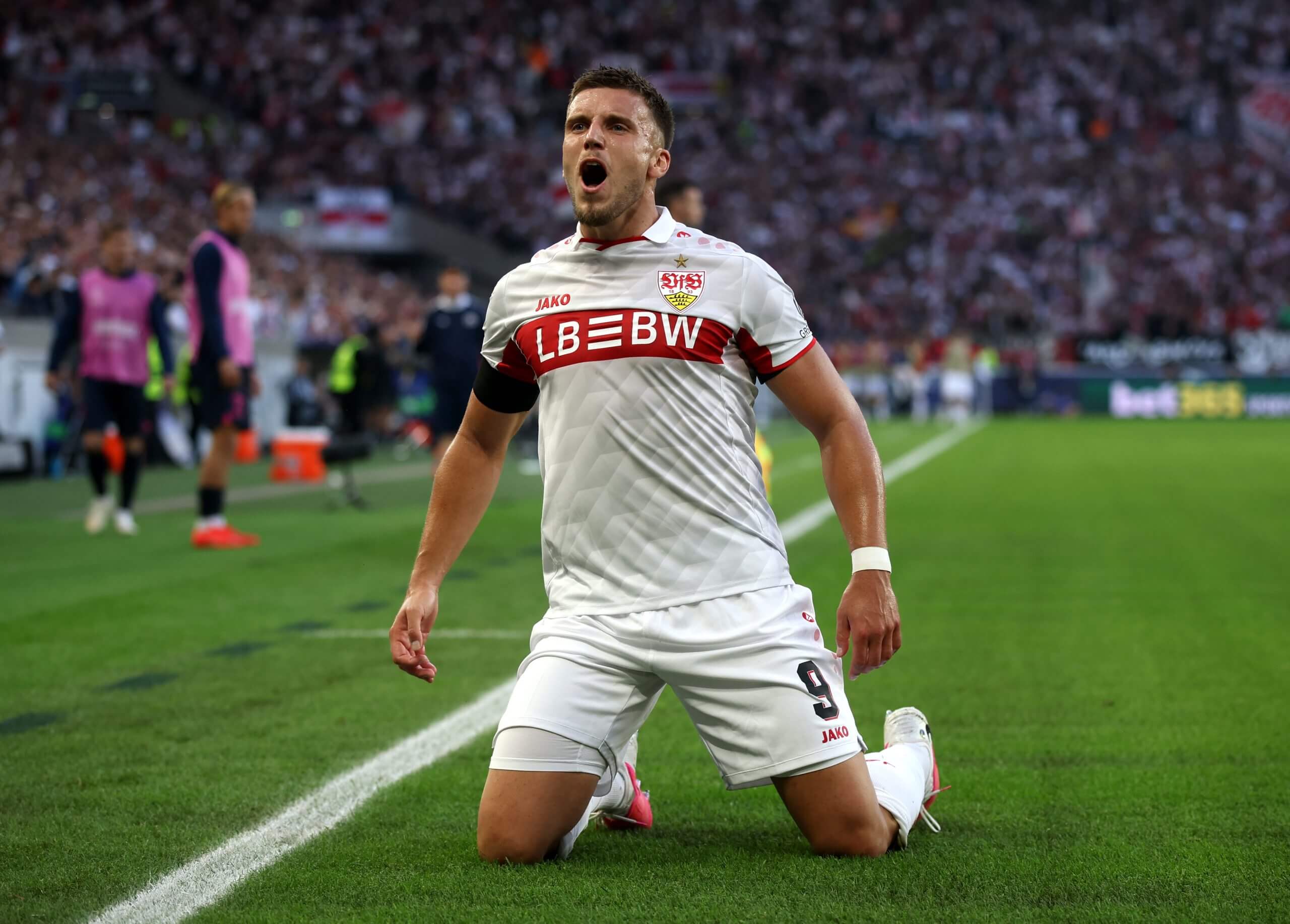 Ermedin Demirovic slides on his knee after his second goal
