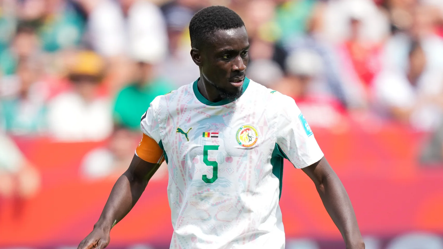 Idrissa Gueye joining Le Mans investors, sparking criticism from advocacy groups.