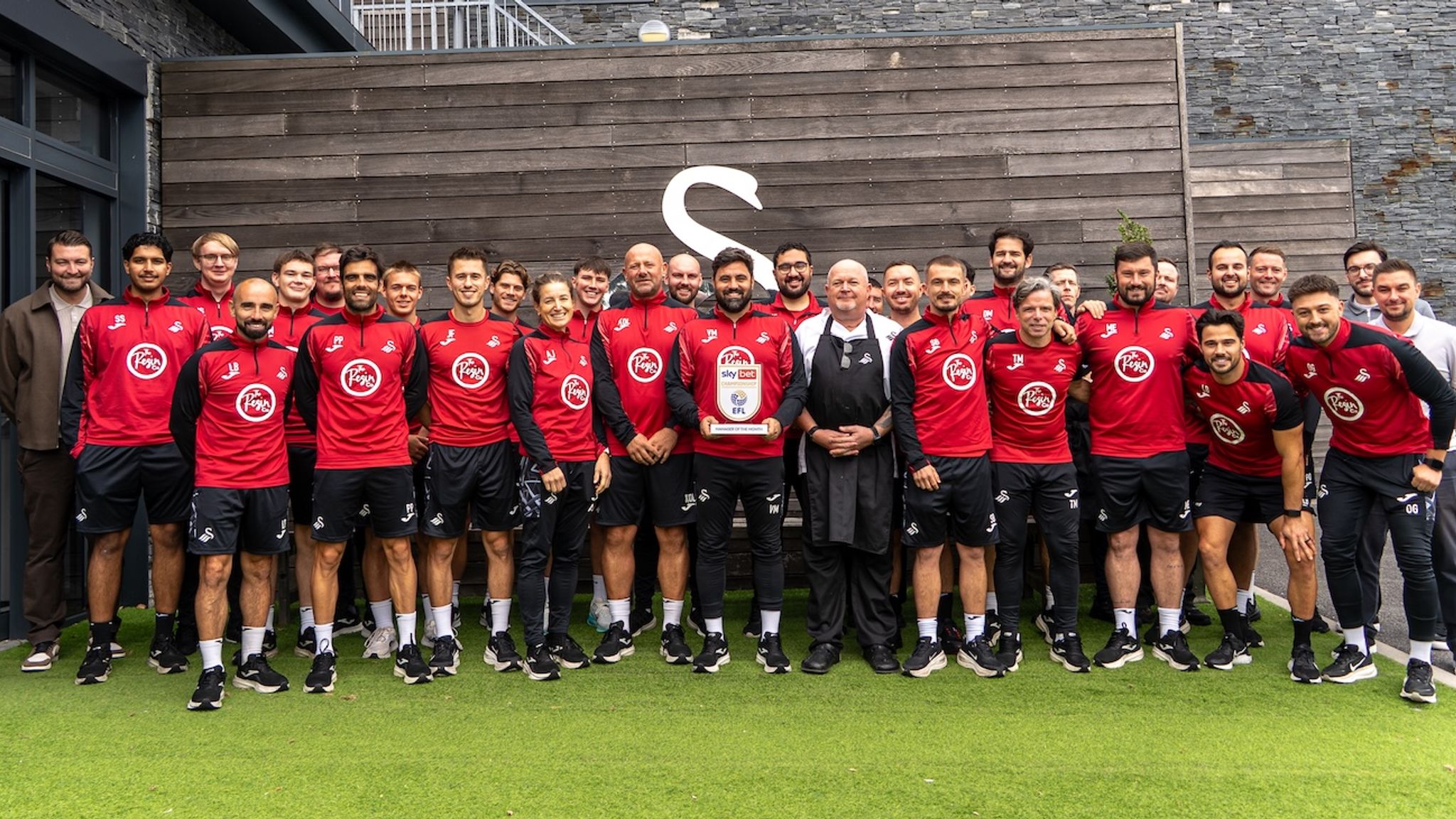 Vitor Matos with Swansea City staff holding the August Sky Bet Championship Manager of the Month award.